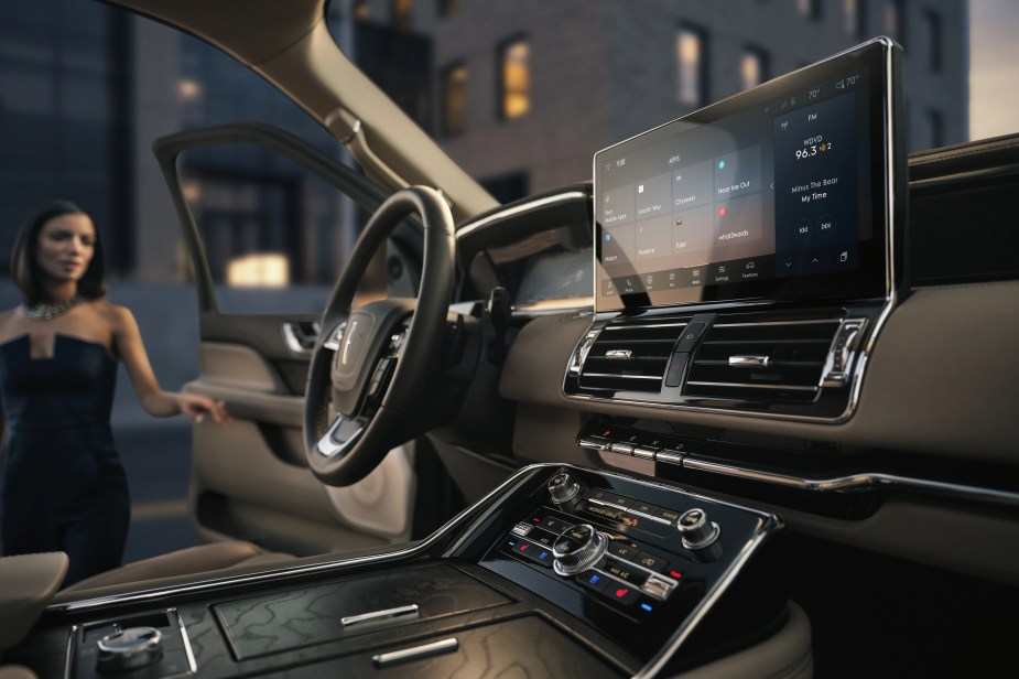 2023 Lincoln Navigator interior with a person approaching.  How much does a fully loaded 2023 Lincoln Navigator cost?