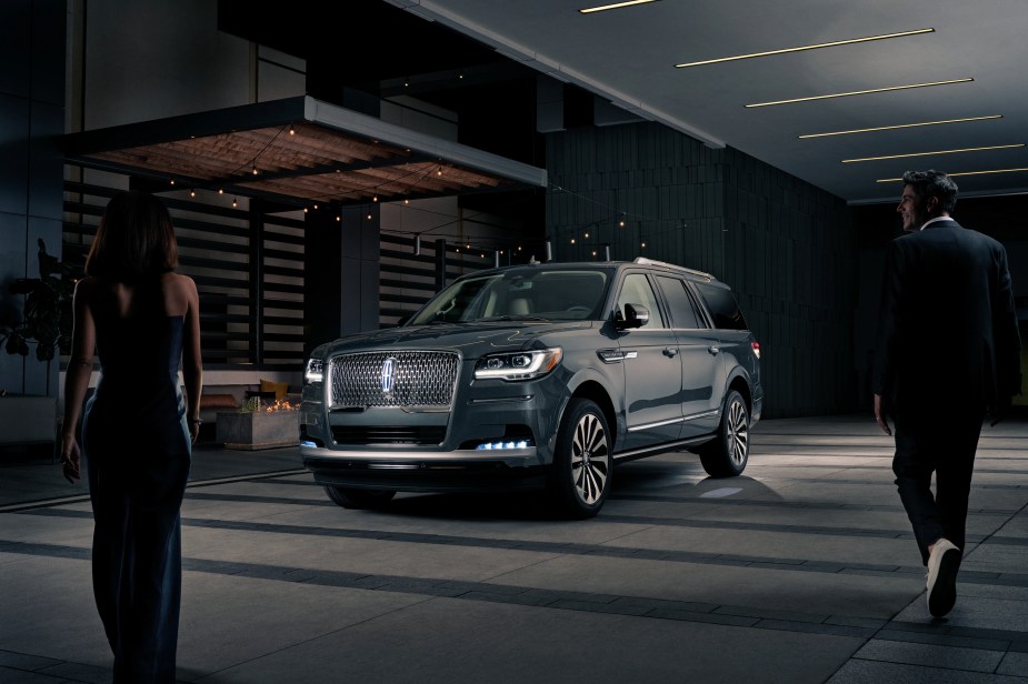 A 2023 Lincoln Navigator parked in a dark parking garage with owners approaching. This luxury full-size SUV lives up to its name.