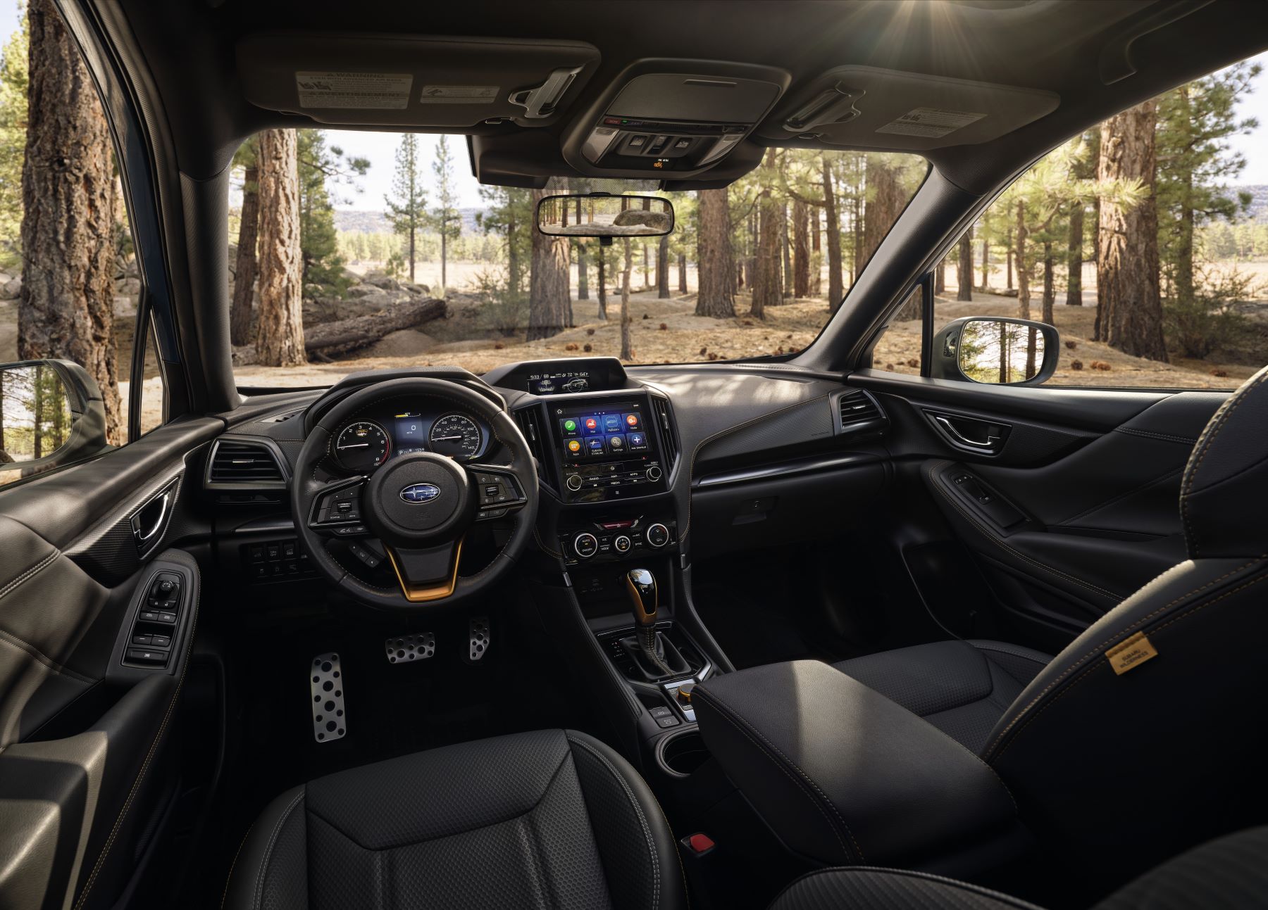 The interior and dashboard layout of a 2023 Subaru Forester compact crossover SUV
