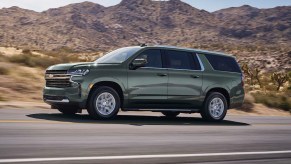 2023 Chevy Suburban luxury SUV full-size model driving outdoors