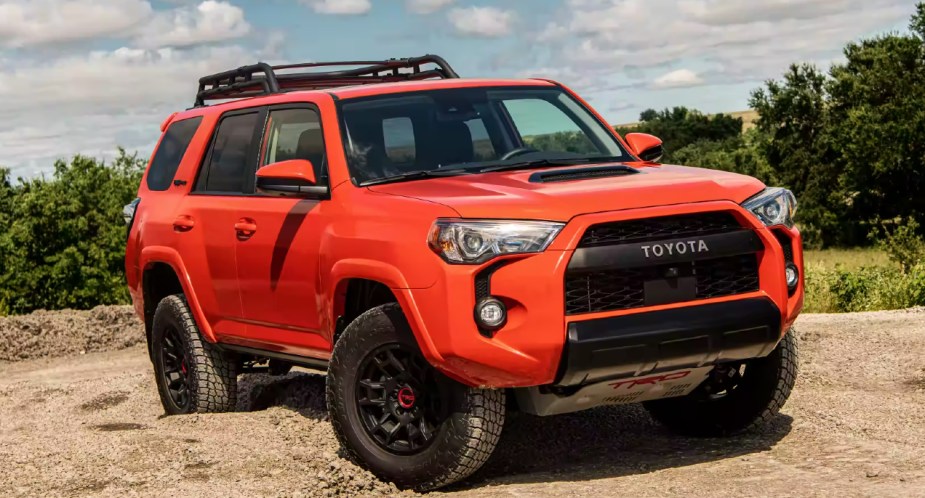 A red 2023 Toyota 4Runner TRD midsize SUV is parked. 