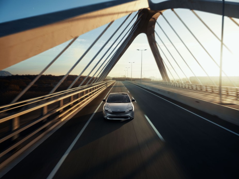 A 2023 Toyota Prius driving across a bridge