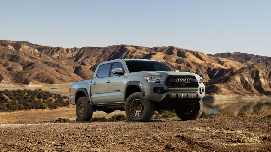 A 2023 Toyota Tacoma Trail Edition midsize pickup truck parked on a plowed dirt field