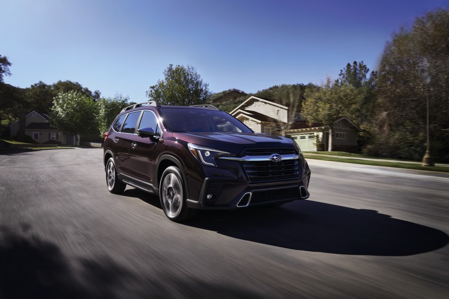 Subaru 2023 rise in purple driving in a neighborhood