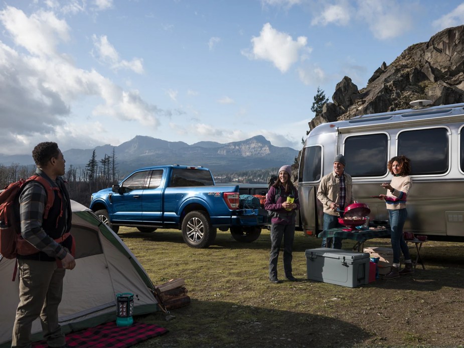 A full-size Ford F-150 XLT SuperCab pickup tows an RV trailer.