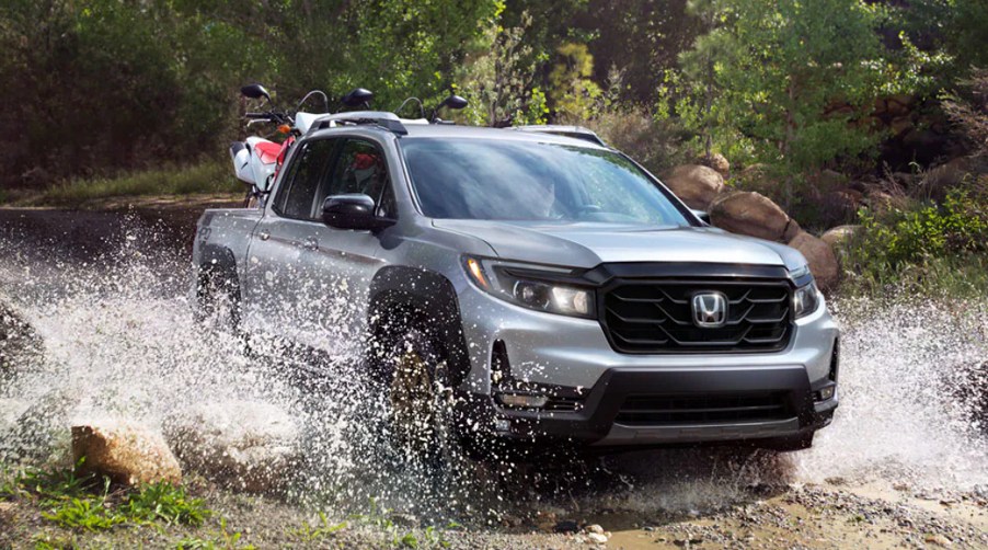 A Honda Ridgeline drives through water, it could soon be a hybrid truck.