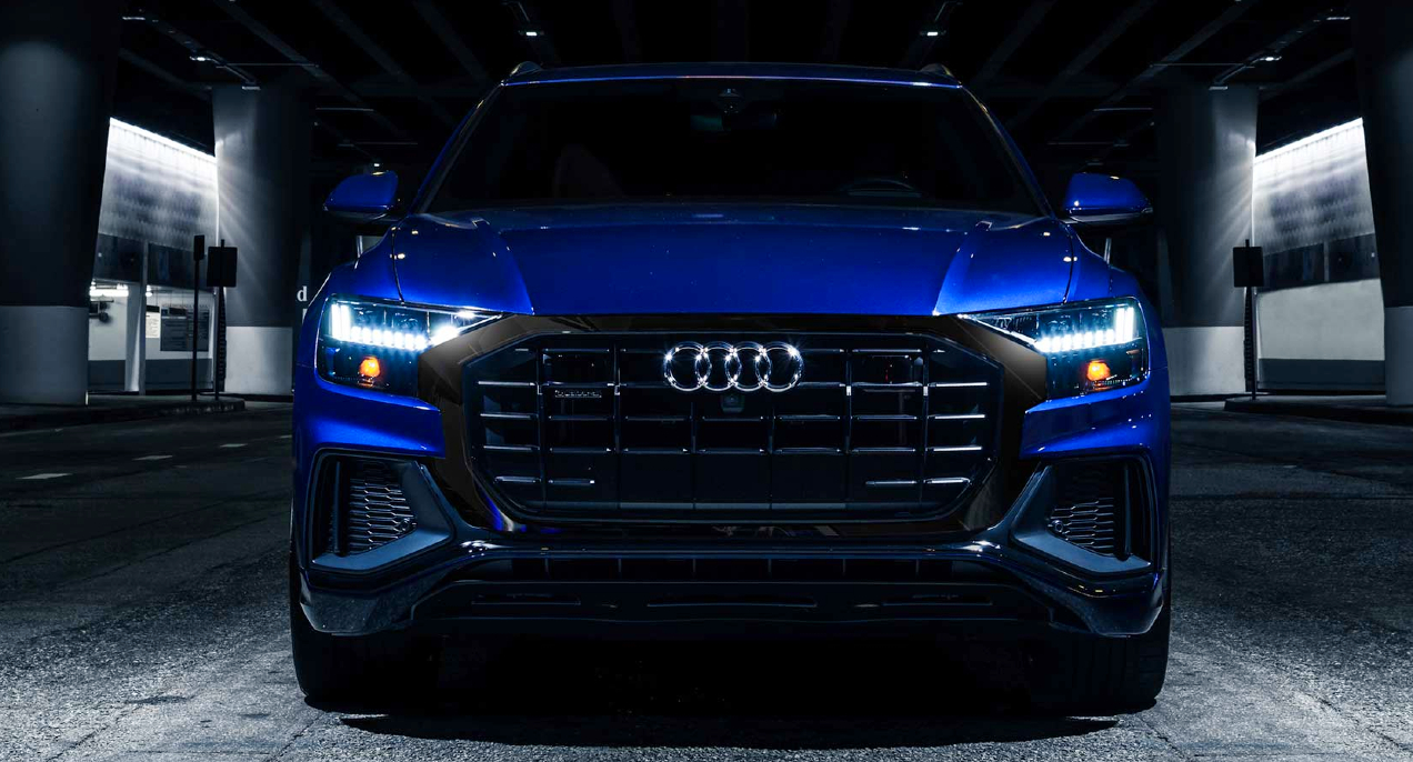 A blue 2023 Audi Q8 luxury midsize SUV is parked.