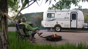The Casita Independence travel trailer parked on the side of a road with a fireplace constructed