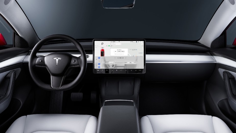 Dashboard and front seats in new 2023 Tesla Model 3 EV, highlighting how much a fully loaded one costs