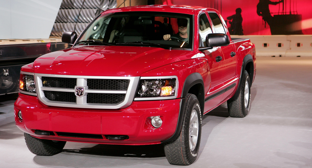 A red 2008 Dodge Dakota midsize pickup truck is parked.