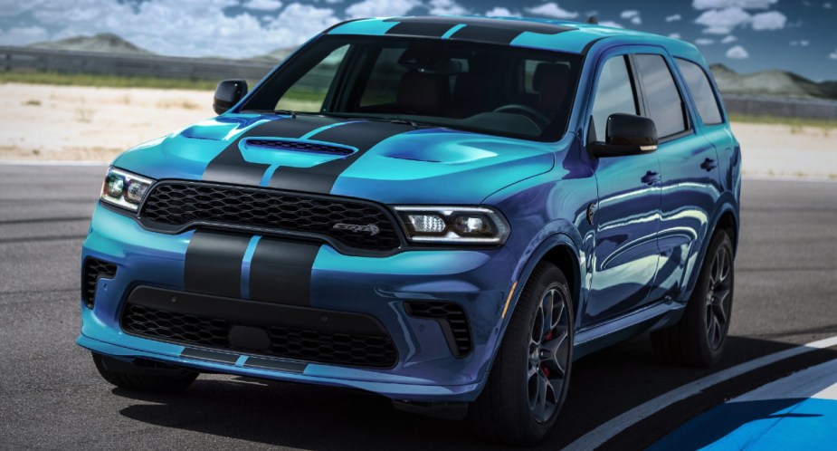 A blue 2023 Dodge Durango SRT Hellcat is parked on a track.