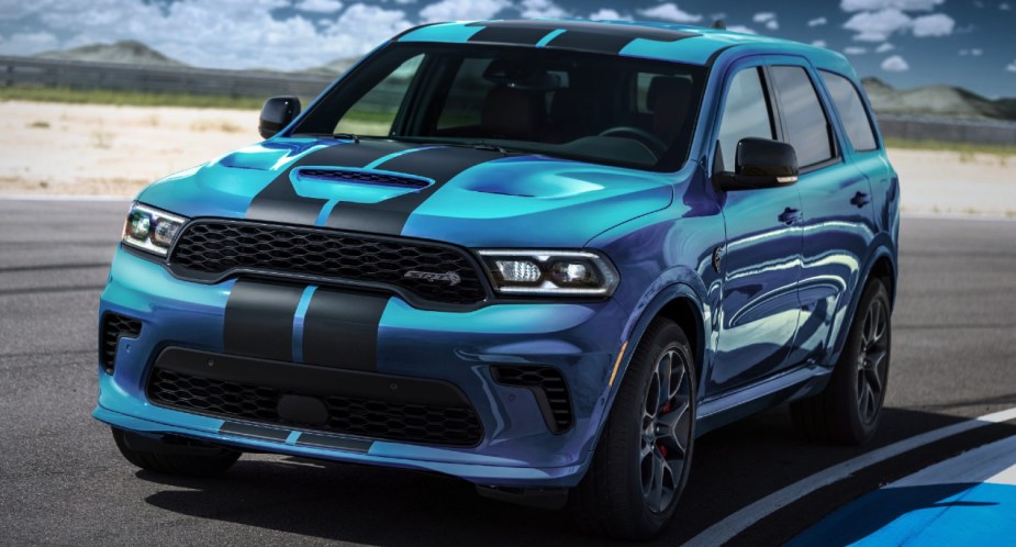 A blue 2023 Dodge Durango SRT Hellcat is parked on a track. 