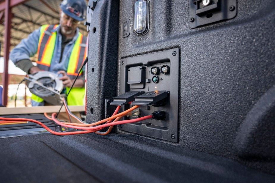 Closeup of the power outlets in the bed of a Ford F-150 PowerBoost hybrid pickup truck.