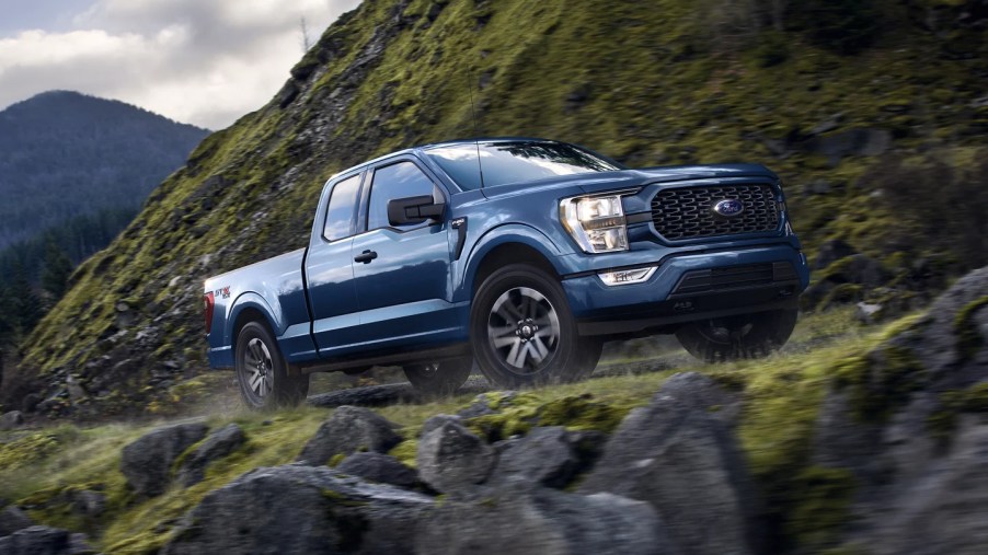 A 2023 Ford F-150 SuperCab cruises on a mountian road.