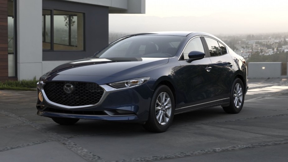 Front angle view of blue 2023 Mazda3, cheaper Honda Civic compact car alternative that's not a Toyota Corolla