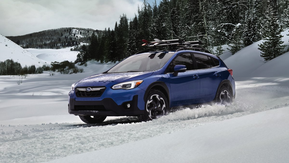 Front angle view of blue 2023 Subaru Crosstrek, one of the cheapest SUVs that's great for snow driving