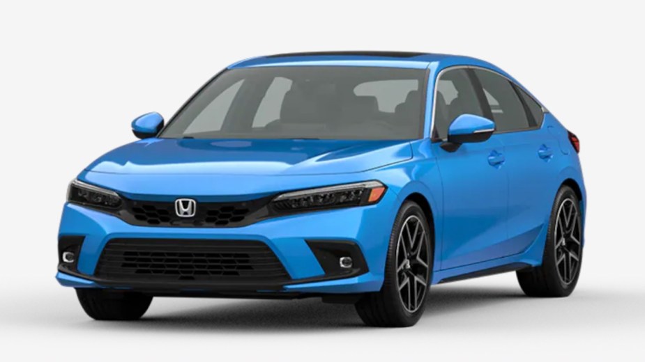 Front angle view of new 2023 Honda Civic Hatchback compact car with Boost Blue Pearl exterior paint color
