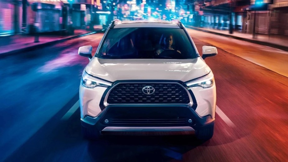 Front angle view of white 2023 Toyota Corolla Cross crossover SUV