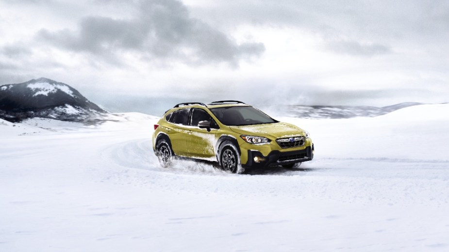 Front angle view of yellow 2023 Subaru Crosstrek, one of the cheapest SUVs that's great for snow driving