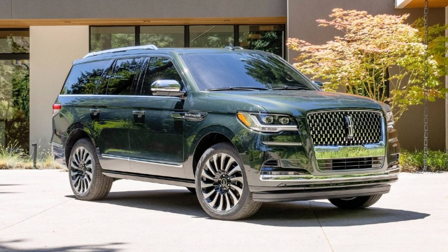 Green Lincoln Navigator Parked in Front of a House