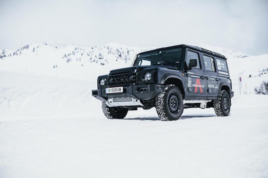 Advertising photo of the Ineos Grenadier 4x4 SUV concept parked in front of snow-capped mountains. 