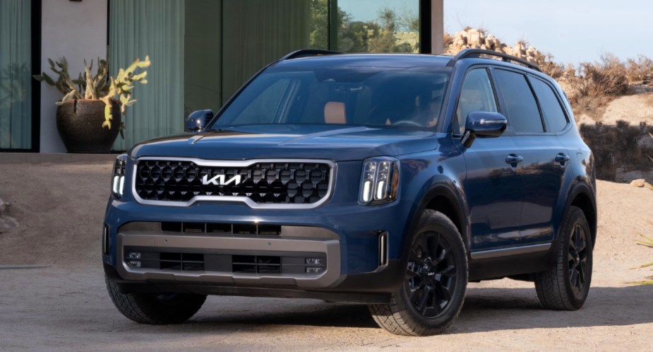 A blue 2023 Kia Telluride midsize SUV is parked, there are a few reasons the SX is the best trim.