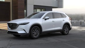 A white 2023 Mazda CX-9 midsize SUV is parked.