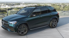 A green 2023 Mercedes-Benz GLE luxury midsize SUV is parked.