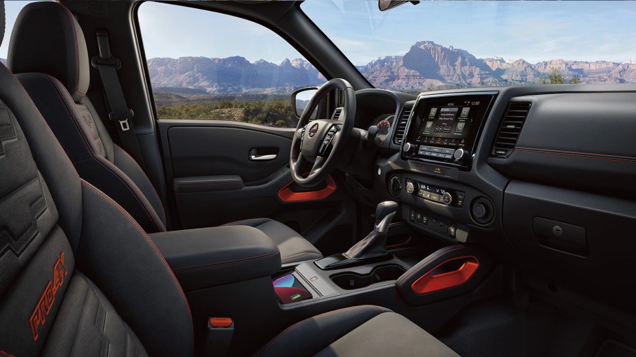 The interior of Nissan's mid-size truck, the 2023 Frontier. It has a lot of modern features, including a touchscreen.