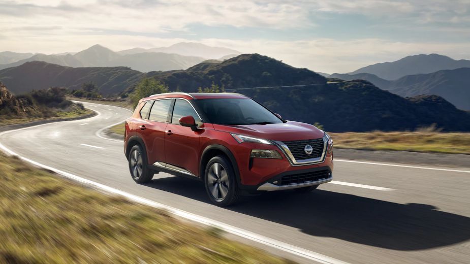 A 2023 Nissan Rogue drives on the road.