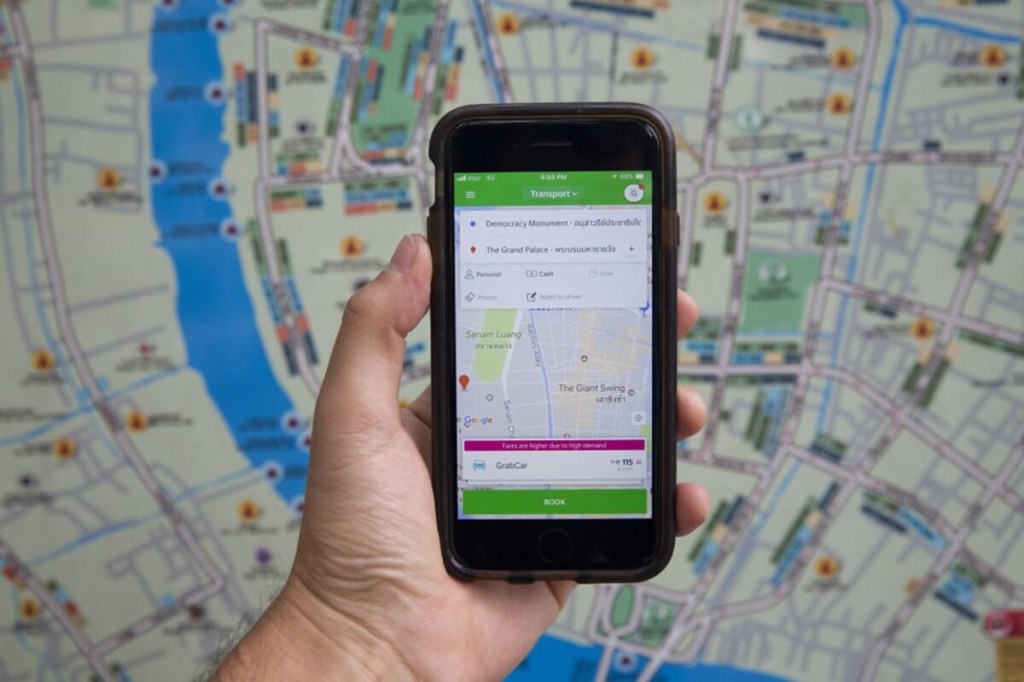 A smartphone uses GPS technology to track a car and map a route. 