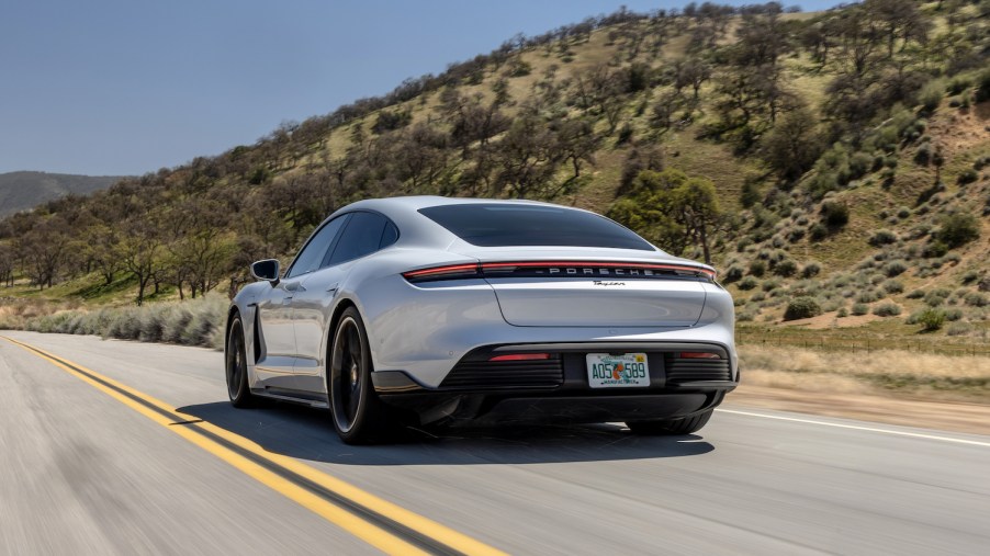 A Porsche Taycan used luxury car driving down an empty road