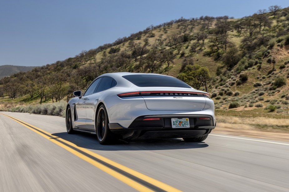 A Porsche Taycan used luxury car driving down an empty road
