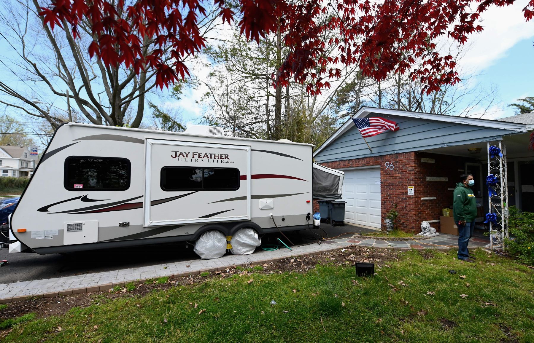 An RV parked in a home driveway in Nutley, New Jersey, which is an example of 'moochdocking'