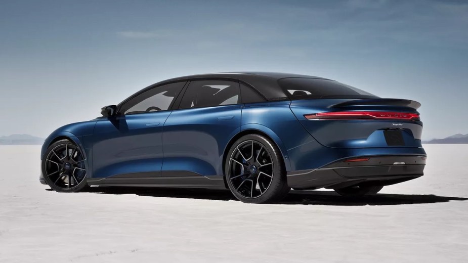 Rear angle view of blue 2023 Lucid Air, which has a higher driving range than all Tesla models