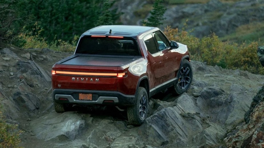 Rear angled view of the orange Rivian R1T, highlighting why car enthusiasts hate electric vehicles