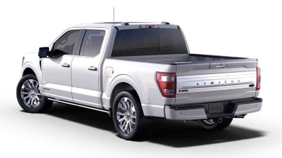 Rear angle view of new white 2023 Ford F-150 Limited pickup truck, highlighting how much fully loaded one costs