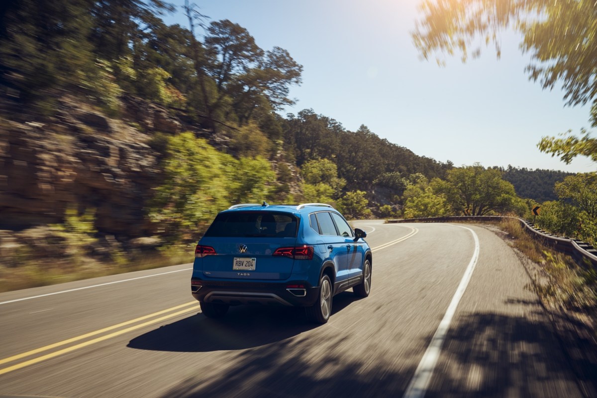 2023 VW Taos in blue on a forest highway