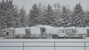 Numerous RVs parked in the snow, possibly finding a way to store an RV for winter.