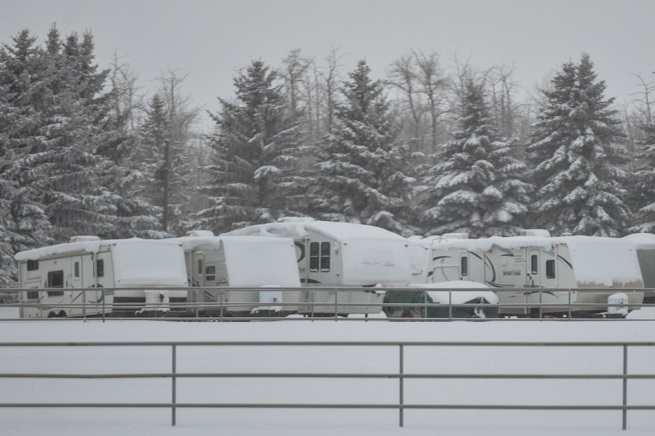 Numerous RVs parked in the snow, possibly finding a way to store an RV for winter.