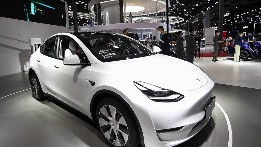 A white Tesla Model Y parked indoors.