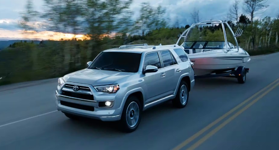 A gray 2023 Toyota 4Runner midsize SUV is towing a boat. 