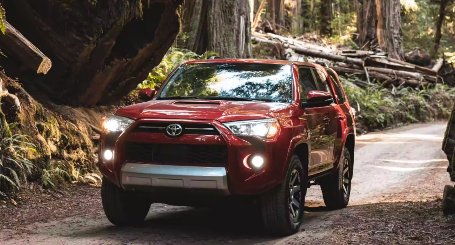 A red 2023 Toyota 4Runner drives off the road. 