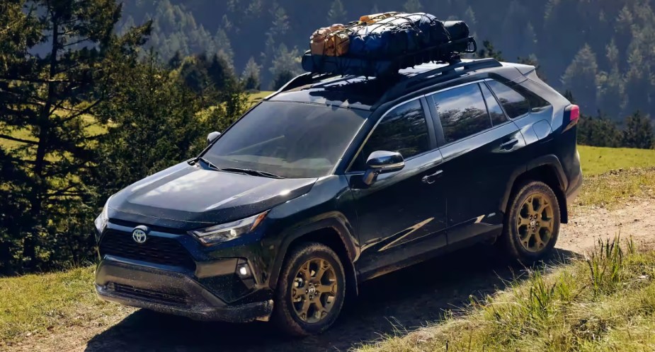 A blue 2023 Toyota RAV4 is driving off-road.