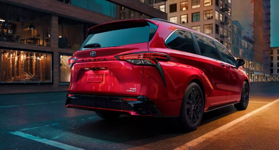 A red 2023 Toyota Sienna is parked. 