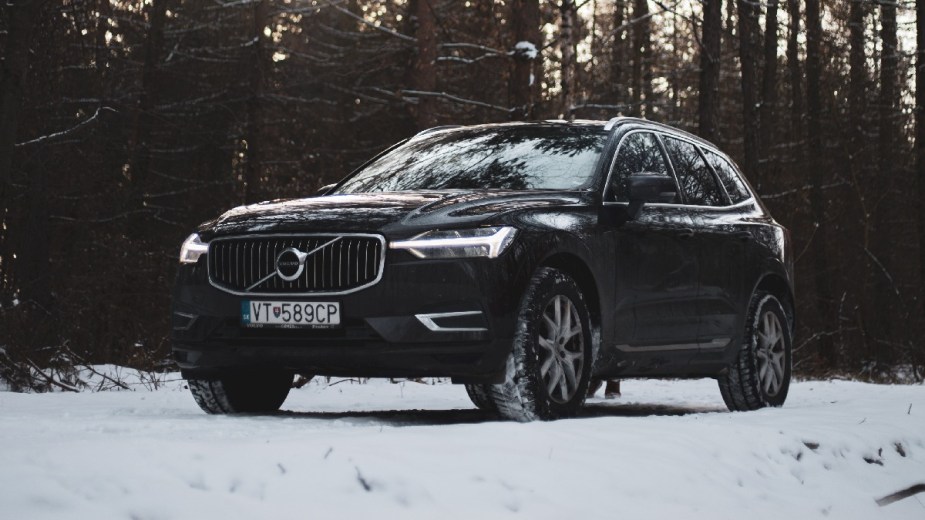 Volvo SUV parked on a snowy road, highlighting if cars with a black color are warmer in the winter