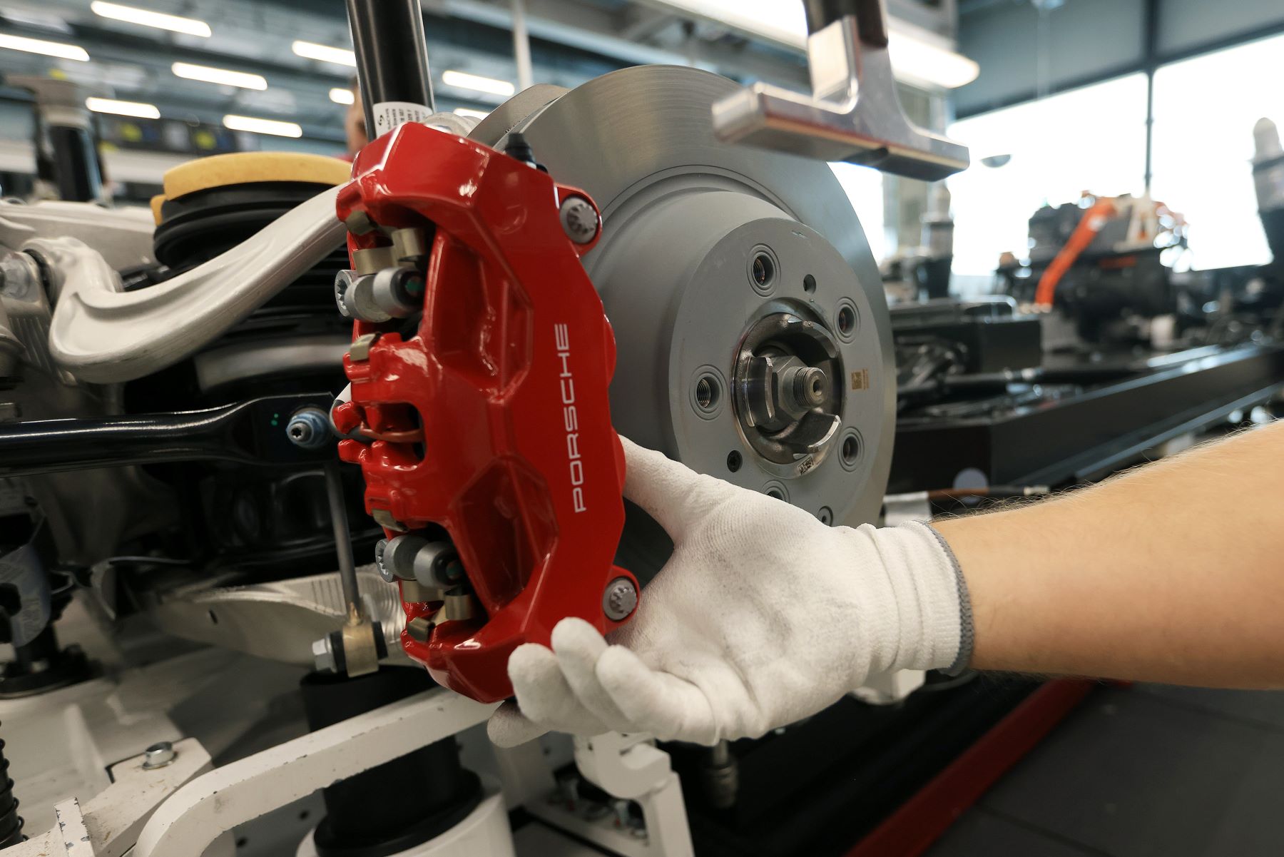 The brake caliper and rotor of an all-electric Porsche Taycan EV during production in Stuttgart, Germany