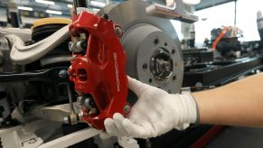 The brake caliper and rotor of an all-electric Porsche Taycan EV during production in Stuttgart, Germany