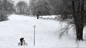 A snow covered scene while someone is riding bike, such as the Engine Pro E-Bike or a normal pedal bike.