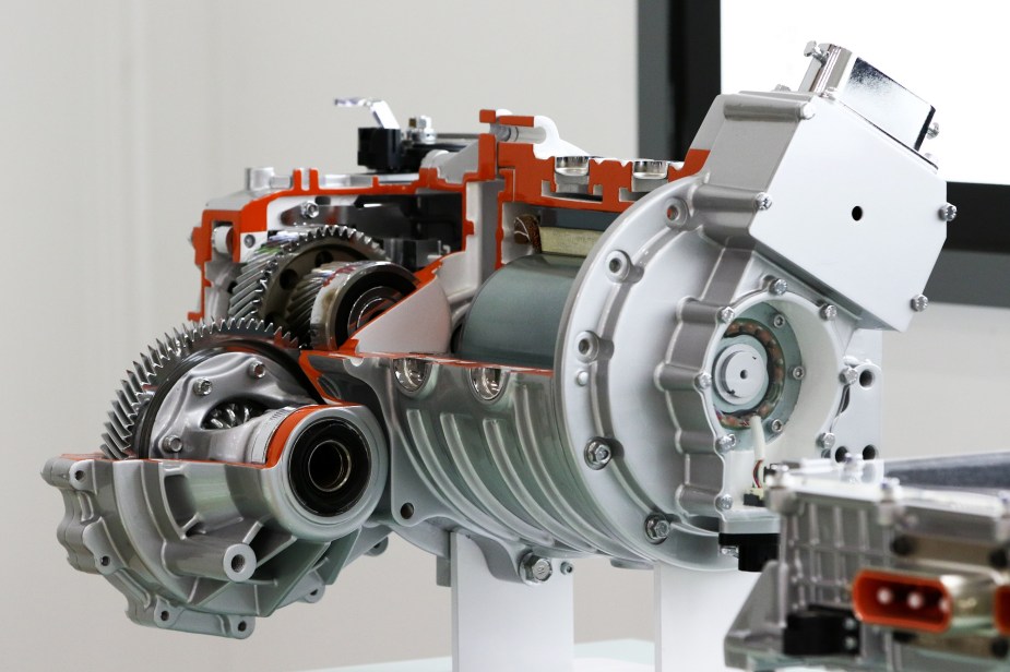 An EV motor with cutaways to show the inner workings of the transmission is shown